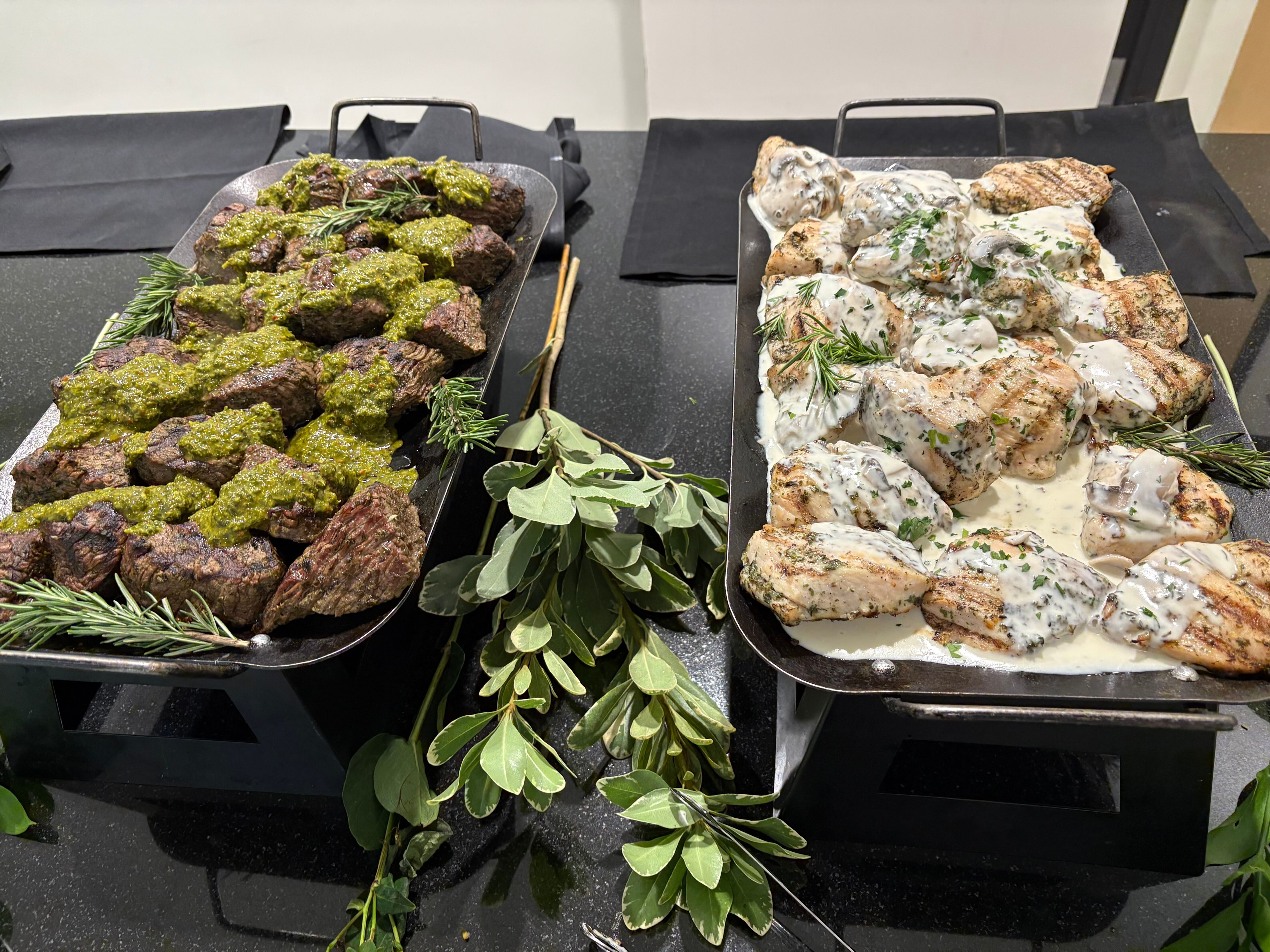 Grilled steak and chicken entrées served at a corporate catering event
