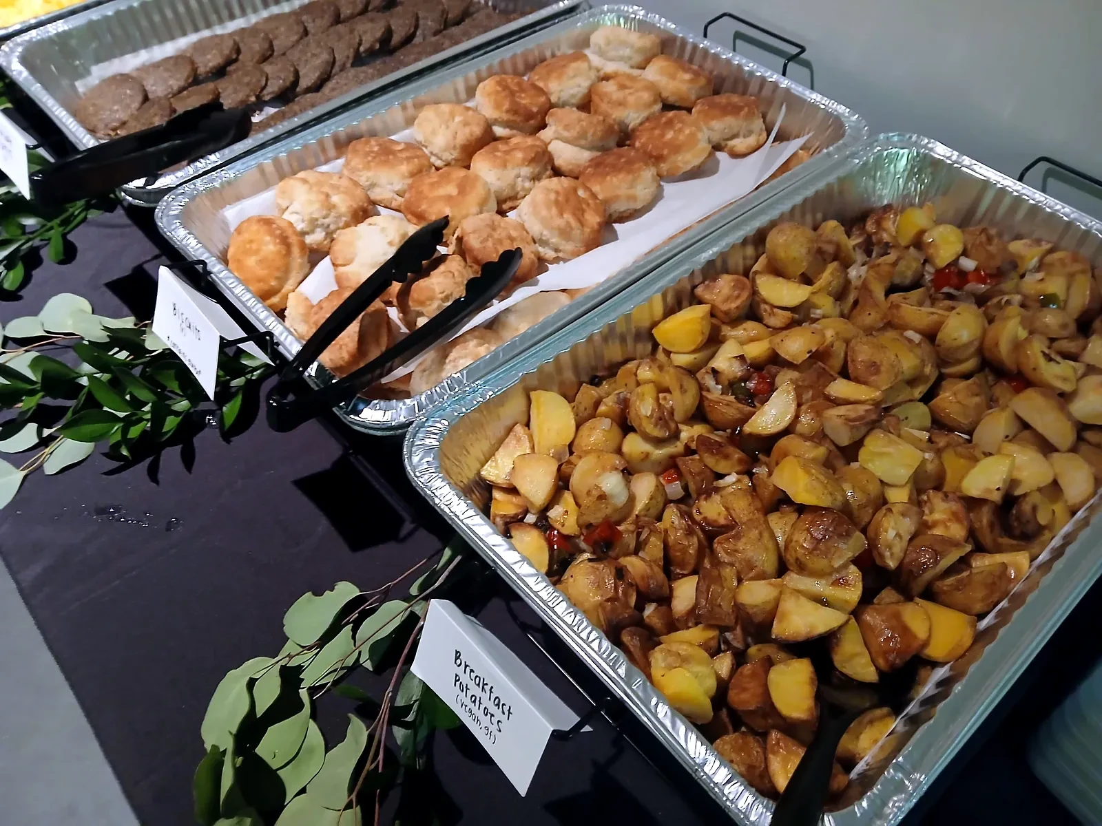 Biscuits and roasted breakfast potatoes in service pans on an Atlanta film set
