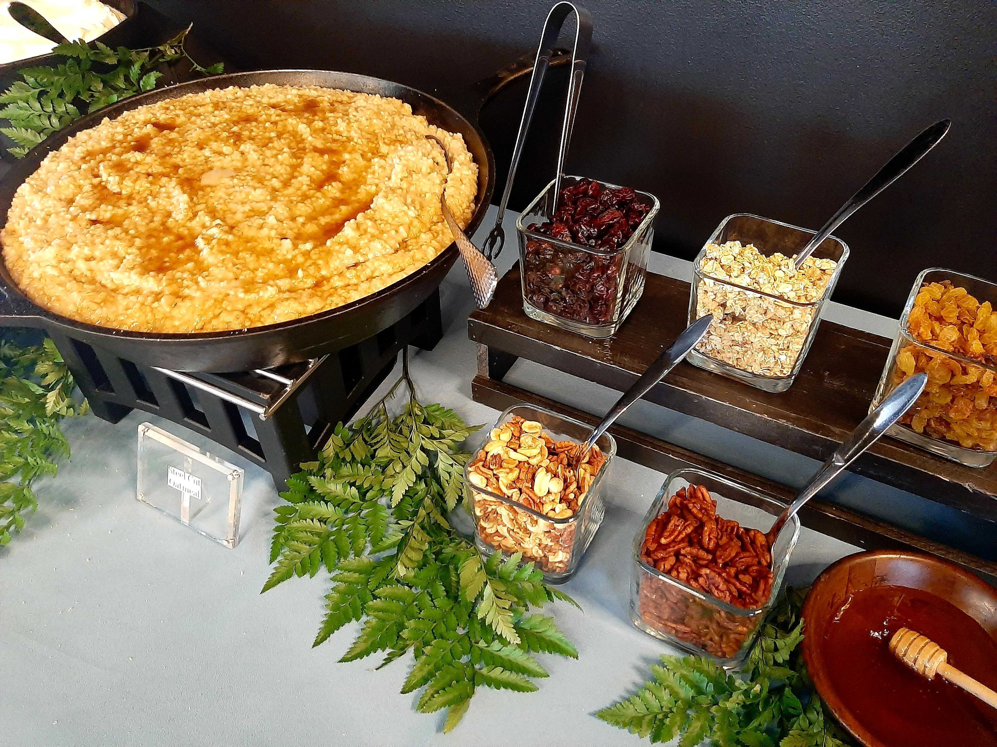 Atlanta production catering paella station with glass topping containers and herb garnishes