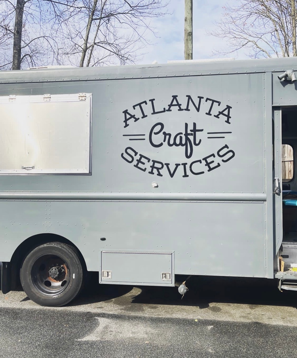 Atlanta Craft Services branded grey craft service truck parked on location at a film production